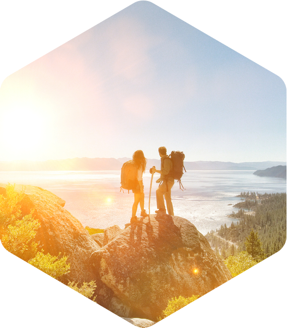 Hikers on mountain at sunset